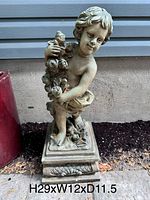Front and side view of an outdoor garden angel statue showing detailed features and condition with slight chips.