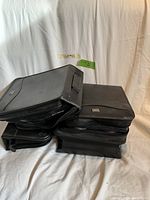 Black binders stacked containing over 600 movie CDs from the early 1990s and 2000s.