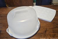 Plastic cake carrier with frosted translucent lid and white base, lid latched