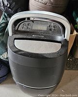 Full view of the Bionaire black dehumidifier showing the handle and overall body shape.