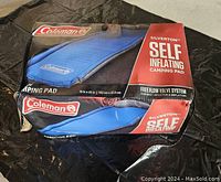 Original packaging showing Coleman Silverton Self Inflating Camping Pad in blue with Free Flow Valve System and size 76" x 22".