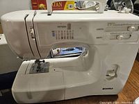 Front and side view of Kenmore sewing machine showing stitch selections and control sliders