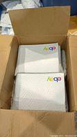 Open box filled with multiple white eBay branded bubble mailers with colorful eBay logos visible on top items.