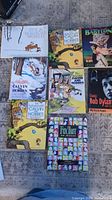 Overview of all eight books laid out showing front covers including multiple Calvin & Hobbes collections, Babylon, Bob Dylan, and Fox Trot.