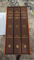 Front view of three book spines inside slipcase, showing titles and author.