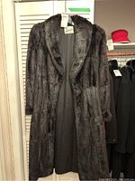 Coat hanging on door showing full front view, color and label.