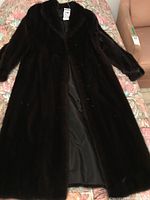 Front view of coat laid flat showing overall length and condition