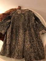 Full view of Persian lamb fur coat showing texture and length.