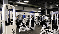 Open gym floor showing Cybex and Atlantis weight machines