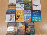 Photo showing eleven assorted books with a mix of bestselling fiction and thematic collections, titles and authors visible.