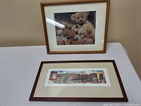 Framed square print of teddy bears and a framed rectangular cityscape puzzle placed on a table.