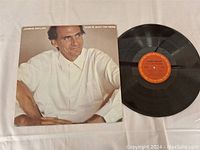 Photo of the James Taylor LP cover and vinyl record shown together on flat surface