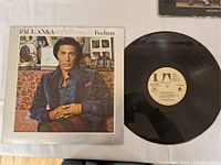 Photo of the vinyl record removed from the sleeve, showing the label and overall vinyl condition.