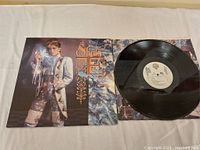 Vinyl record partially removed from cover; cover displays photo of woman and album title.