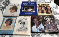 Front covers of seven hardcover books about British royalty with dust jackets featuring images of Diana Princess of Wales, the Queen Mother, Prince Philip, the Queen, and other royal portraits.