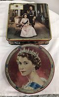 Square Royalty Biscuit Tin showing the front lid with Queen Elizabeth II and Prince Philip portrait inside a formal room.
