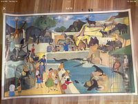 Photo showing the 'Le Zoo' side of the educational poster with numerous illustrated animals and zoo visitors in color.