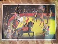Photo of the circus illustration side of the double-sided educational poster, showing performers, horses, and a colorful circus ring scene.