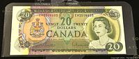 Front side of the 1969 Canadian 20 dollar banknote showing Queen Elizabeth II portrait, Canadian coat of arms, serial number, and denomination.