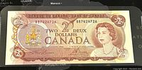 Front side of the 1974 Canadian $2 banknote showing Queen Elizabeth II with serial number.