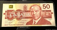 Front of 1988 Canadian $50 banknote showing portrait of William Lyon Mackenzie King with Ottawa 1988 marking and denomination in corners.