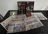 Lot of Toronto Blue Jays memorabilia highlighting their 1992 and 1993 World Series wins including newspapers and books.