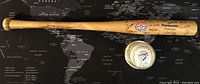 Photo showing full wooden baseball bat with team signatures and logos including Panasonic Cellular and Jays Champions logo.