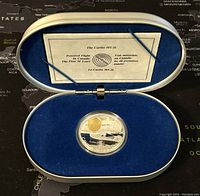 Silver proof coin of The Curtiss HS-2L in blue velvet-lined oval display case with informational card.