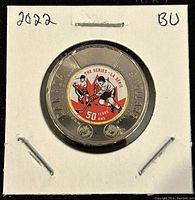 Front side of the 2022 Canadian twoonie coin showing the colorized hockey players and commemorative text.