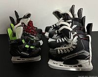 Four pairs of Bauer hockey skates in a row showing different sizes and styles.