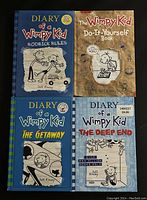 Front view of four Diary of a Wimpy Kid hardcover books arranged in a 2x2 grid showing titles 'Rodrick Rules,' 'Do-It-Yourself Book,' 'The Getaway,' and 'The Deep End'. Covers feature cartoon drawings and vibrant colors.