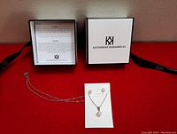 Photo showing the necklace and earring set displayed with Katherine Karambelas branded box, including care instructions card.