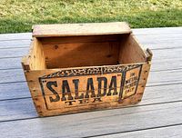 Front angled view of the wooden crate showing Salada Tea logo and open interior.