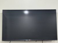 Photo of the large flat-screen LG Smart TV showing the front view of the TV screen with slim bezel.