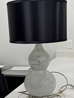 Front view showing the rhinestone-studded dual-gourd shape base and black drum lampshade on a white surface.