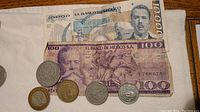 Mexican paper money banknotes 10000 and 100 pesos, and 4 Mexican coins.