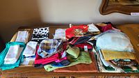 Overview of assorted handkerchiefs and fabric pieces arranged on a table.