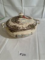 Front angled view of ceramic tureen with lid, showing winter village design and one handle