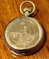 Hunter case pocket watch front showing embossed hunting scene design