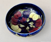 Top view of the bowl showing the detailed colorful fruit design on a blue background.