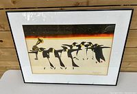 Full image of the framed artwork depicting penguins dancing around a gramophone with starry night background and orange horizon.