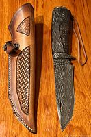 Knife seated in leather sheath on wood surface