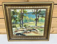 Frontal view of vintage oil painting in gold-tone decorative frame showing lake and trees landscape