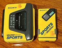 Top view of both yellow Sony Walkman units showing front panels, branding, and controls.