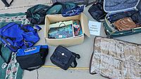 Overview photo showing multiple bags including Cabela's bag, purses, duffel bags and shoe storage organizer