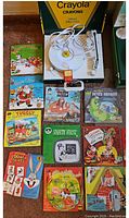 Full view of record player, story records, and musical multiplication record laid out showing colorful illustrated covers and box with crayons graphics