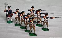 Group photo showing all eight French infantrymen toy soldiers arranged in two rows displaying their muskets and uniforms.