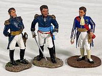 Photo of three hand painted French military officer and dignitary toy soldiers showing their uniforms and bases.