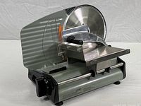 Photo of entire Intertek food slicer, showing the unit's base, cutter, and food carriage.