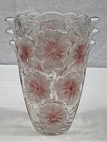 Front view showing the clear glass vase with pink pansy flower embossing and scalloped edge